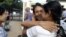 A prisoner, center, is welcomed by her relative outside Insein prison in Rangoon after the government released prisoners Nov. 15, 2012. 