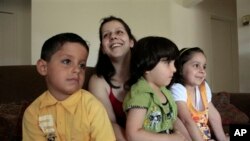 Iraqi refugee Rawaa Bahoo smiles with her children in Farmington Hills, Mich. 