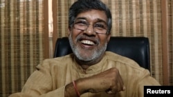 Indian children's rights activist Kailash Satyarthi laughs at his office in New Delhi October 10, 2014.