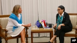 FILE - European Union Foreign Policy Chief Federica Mogherini, left, and Indonesian Foreign Minister Retno Marsudi talk during a meeting on the sidelines of the 50th ASEAN Foreign Ministers' Meeting and Related Meetings in Manila, Philippines, Monday, Aug. 7, 2017.