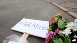 A sign declaring "Not Afriad" placed near to the cultural club where one person was killed in Copenhagen, Denmark, Sunday, Feb. 15, 2015.