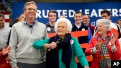 FILE - Barbara Bush, center, jokes with her son, Republican presidential candidate, former Florida Gov. Jeb Bush, while introducing him at a town hall meeting at West Running Brook Middle School in Derry, N.H., Feb. 4, 2016.