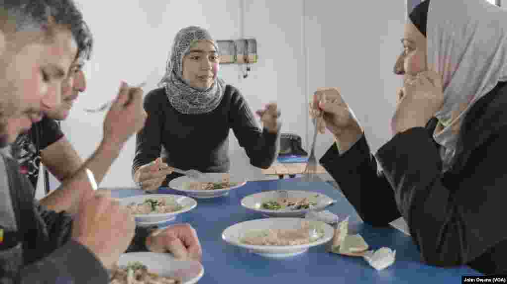 A group of refugees enjoys one of the daily lunches served at the Khora center, in the Exarchia district in Athens, Greece, Oct. 24, 2016.