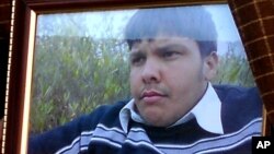 An undated framed photograph shows 15-year-old Pakistani student Aitzaz Hasan, who died while trying to stop a suicide bomber who was targeting his school. 