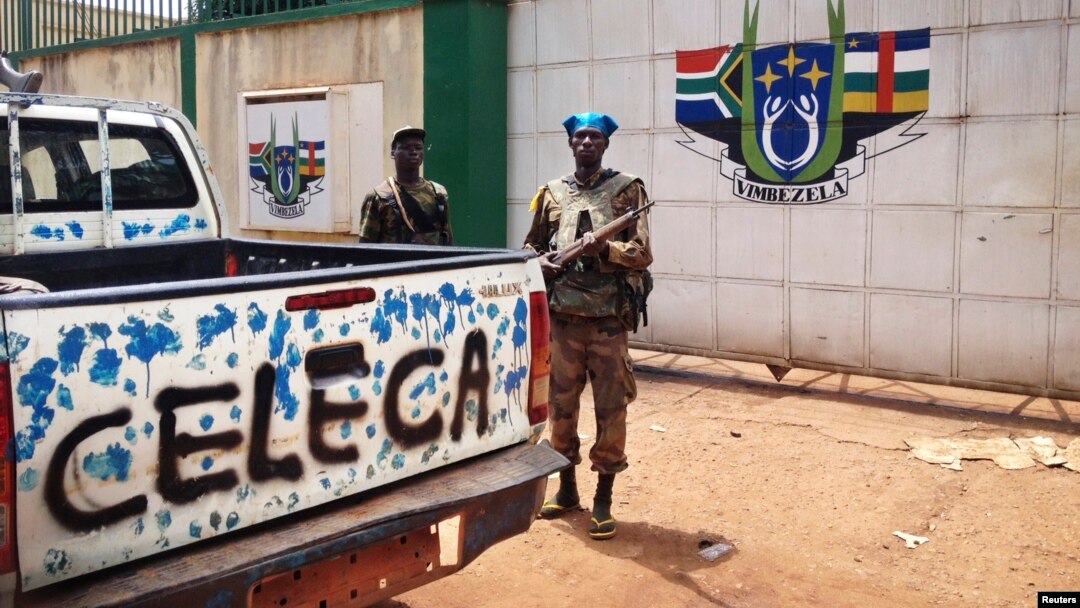 A fighter from the Seleka rebel coalition stands guard in front of the abandoned South African military camp in Bangu on March 26, 2013.