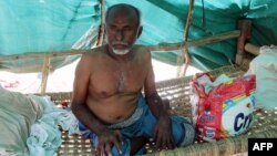 FILE - A displaced Yemeni from Hodeida sits in a shelter at a makeshift camp in a village in the northern district of Abs in Hajjah province, Sept. 16, 2018.