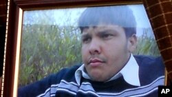 An undated framed photograph shows 15-year-old Pakistani student Aitzaz Hasan, who residents and police say died this week while trying to stop a suicide bomber who was targeting his school in a remote village in Hangu, Pakistan, Jan. 10, 2014.