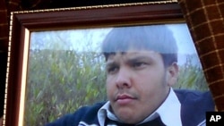 An undated framed photograph shows 15-year-old Pakistani student Aitzaz Hasan, who residents and police say died this week while trying to stop a suicide bomber who was targeting his school in a remote village in Hangu, Pakistan, Jan. 10, 2014.