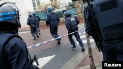 French intervention police take up position near the scene of a hostage taking at a kosher supermarket in eastern Paris January 9, 2015, following Wednesday's deadly attack at the Paris offices of weekly satirical newspaper Charlie Hebdo by two masked gun