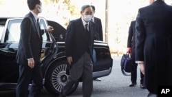 Prime Minister Yoshihide Suga wearing a face mask arrives at the National Theatre of Japan to attend the national memorial service for the victims of the March 11, 2011, earthquake and tsunami in Tokyo, March 11, 2021.
