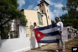 FILE - Ladies in White, a women's dissident group that calls for the release of political prisoners, marches in Havana, Cuba, March 20, 2016.