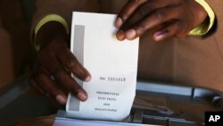 A man casts his vote at a polling station in Harare, Zimbabwe, Monday, July 30, 2018. (AP Photo/Tsvangirai)