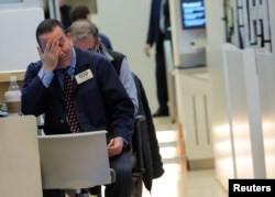 Traders who work on the floor of the New York Stock Exchange in New York, Dec. 14, 2018, react to a tough day as stocks fell sharply.