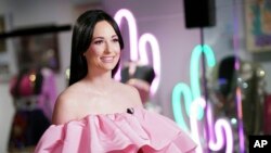 Country singer Kacey Musgraves poses in front of her new exhibit at the Country Music Hall of Fame and Museum in Nashville, Tennessee, July 1, 2019. 