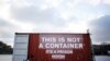 FILE - A shipping container bearing the slogan "This is not a container, it is is prison" stands in position during a demonstration by Reporters Without Borders in support of imprisoned journalists, including those from Eritrea, in Paris, Dec. 16, 2014.