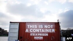 FILE - A shipping container bearing the slogan "This is not a container, it is is prison" stands in position during a demonstration by Reporters Without Borders in support of imprisoned journalists, including those from Eritrea, in Paris, Dec. 16, 2014.