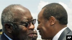 Ivorian president Laurent Gbagbo (L) and Burkina Faso's president Blaise Compaore meet at the airport in Abidjan on 22 Feb, 2010 after Campaore arrived to act as a mediator in Ivory Coast's political crisis