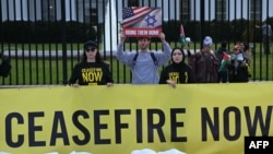 FILE — Demonstrators supporting Israel hold signs next to demonstrators calling for a cease-fire, in front of the White House in Washington, DC, Nov. 15, 2023. 