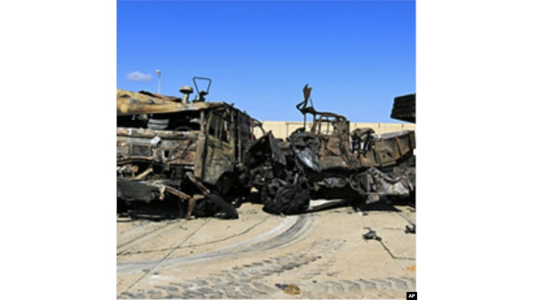 Destroyed military vehicles are seen at a naval military facility after last night's coalition air strikes in People's Port in eastern Tripoli, March 22, 2011