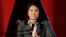 FILE - Presidential candidate Keiko Fujimori reads a statement to the press in Lima, Peru, June 5, 2011. 