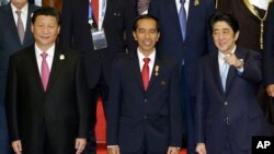 Presiden Joko Widodo, Presiden China Xi Jinping (kiri) dan Perdana Menteri Shinzo Abe bersiap berfoto bersama dalam Konferensi Asia Afrika di Jakarta (22/4). (AP/Dita Alangkara)