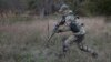 (FILE) A recruit holds his weapon as he runs during a military training in southern Russia.