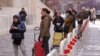 People line up to enter a supermarket, keeping the proscribed social distance from one another and entering a few at a time, in keeping with measures introduced by the Italian government to slow the spread of the coronavirus, in Rome, March 10, 2020.
