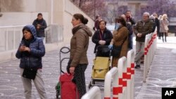 People line up to enter a supermarket, keeping the proscribed social distance from one another and entering a few at a time, in keeping with measures introduced by the Italian government to slow the spread of the coronavirus, in Rome, March 10, 2020.