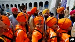 Sikh youth attending a ceremony during the Vasakhi festival, at the shrine of Gurdwara Punja Sahib, the second most sacred place for Sikhs, in Hasan Abdal, some 50 kilometers from Islamabad, Apr. 14, 2019.
