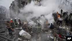Rescuers work at the scene of a building damaged by Russian rocket attack in Kharkiv, Ukraine, Jan. 23, 2024.