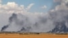 FILE - Smoke rises from Manbij city, Aleppo province, Syria, June 8, 2016. 