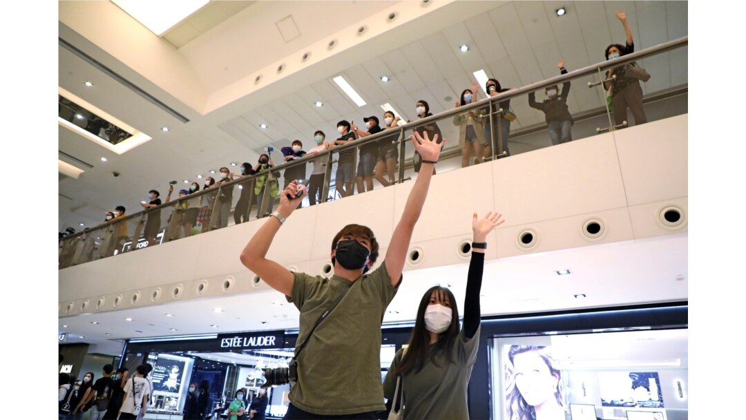 Protesters display open palm with five fingers, signifying the "Five demands - not one less", during the Labor Day in Hong Kong, May 1, 2020.