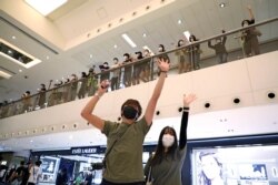 Protesters display open palm with five fingers, signifying the "Five demands - not one less", during the Labor Day in Hong Kong, May 1, 2020.