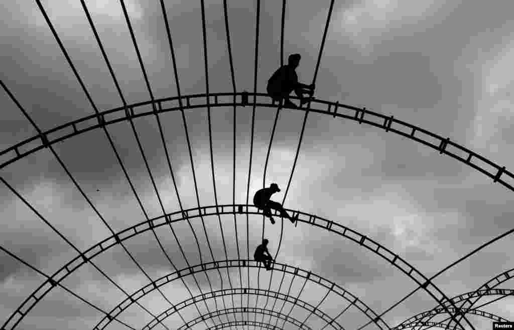 Men work on top of a marquee for an event in Colombo, Sri Lanka.