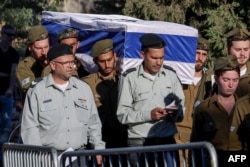 Israeli soldiers carry the coffin of fellow soldier Agam Naim, 20, who served as a paramedic, during a funeral in Kibbutz Mishmoret, Israel, on Sept. 18, 2024. The Israeli military said that four soldiers were killed in fighting in southern Gaza the previous day.