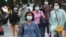 FILE - People wearing face masks to protect against the spread of the coronavirus cross and intersection in Taipei, Taiwan, Nov. 20, 2020. 