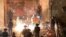 Palestinians react as Israeli police fire a stun grenade during clashes at Damascus Gate on Laylat al-Qadr during the holy month of Ramadan, in Jerusalem's Old City, May 9, 2021. 