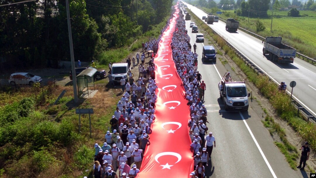 Ribuan pendukung memegang bendera nasional sepanjang 1.100 meter saat mengikuti Kemal Kilicdaroglu,pemimpin oposisi utama Turkey, Partai Rakyat Republik pada hari ke-17 pawai 425 kilometer di Sakarya, 220 kilometer dari ibukota Ankara, Turki, 1 Juli 2017. (Foto: dok).