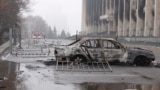 A view shows a burnt car following the protests triggered by fuel price increase outside the city administration headquarters in Almaty, Kazakhstan, Jan. 7, 2022. 