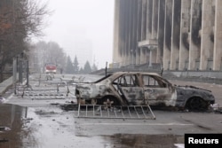 A view shows a burnt car following the protests triggered by fuel price increase outside the city administration headquarters in Almaty, Kazakhstan, Jan. 7, 2022.