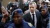 FILE PHOTO: FILE PHOTO: Oscar Pistorius is escorted by police officers as he arrives for his sententencing for the 2013 murder of his girlfriend Reeva Steenkamp, at North Gauteng High Court in Pretoria, South Africa