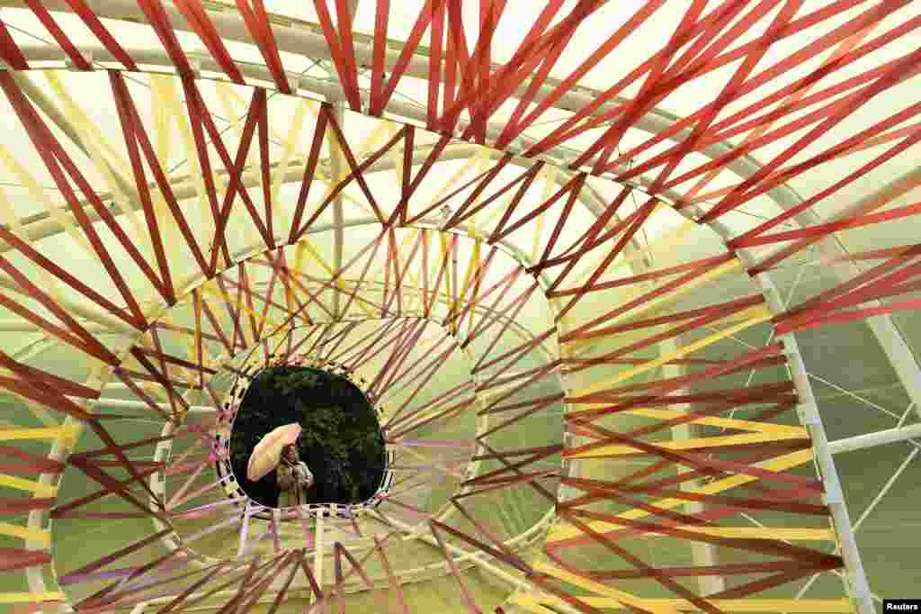 Serpentine exhibition curator Emma Enderby views the Serpentine Summer Pavilion in Hyde Park in London, Britain. The 15th annual architectural commission is a double-skinned polygonal translucent structure designed by Spanish architects Jose Selgas and Lucia Cano.