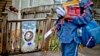 USPS carrier Jamesa Euler encounters barking dog in the Cabbagetown neighborhood of Atlanta, Ga., Feb. 7, 2013.