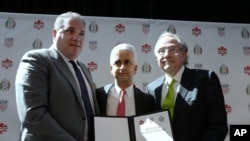 FILE - In this April 10, 2017, photo, Victor Montagliani, left, President of the Canadian Soccer Association, Sunil Gulati, center, President of the United States Soccer Federation, and Decio de Maria, President of the Mexican Football Federation, show their unified bid to co-host the 2026 World Cup, in New York. 