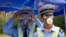 Chinese traffic police wear masks as they man a security checkpoint near the site of an explosion in northeastern China's Tianjin municipality, Aug. 15, 2015.