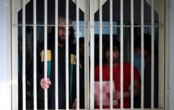 FILE - Jailed Taliban fighters are seen inside the Pul-e-Charkhi prison in Kabul, Afghanistan, Dec. 14, 2019.