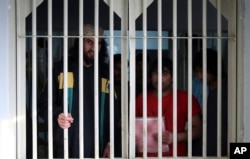 FILE - Jailed Taliban fighters are seen inside the Pul-e-Charkhi prison in Kabul, Afghanistan, Dec. 14, 2019.