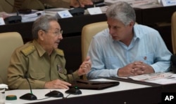 FILE - Cuba's President Raul Castro, left, talks with Vice President Miguel Diaz-Canel during the opening of the National Assembly session in Havana, Cuba, July 8, 2016.