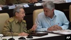 FILE - Cuba's President Raul Castro, left, talks with First Vice President Miguel Diaz-Canel during the opening of the National Assembly session in Havana, Cuba, July 8, 2016. 