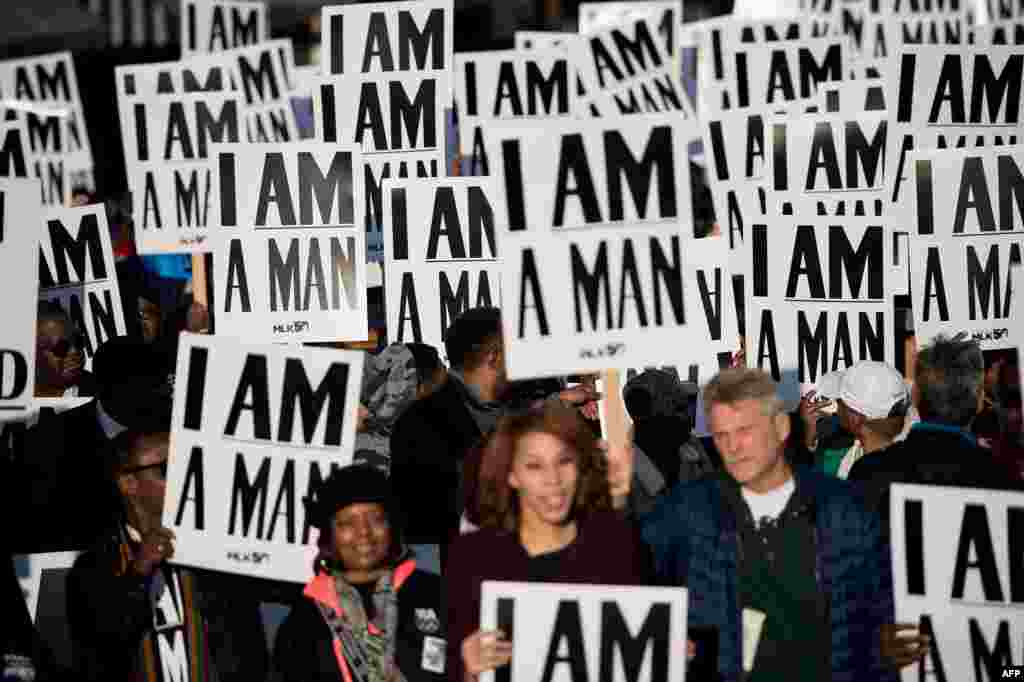 People wait to march to commemorate the 50th anniversary of the assassination of Martin Luther King Jr., in Memphis, Tennessee.